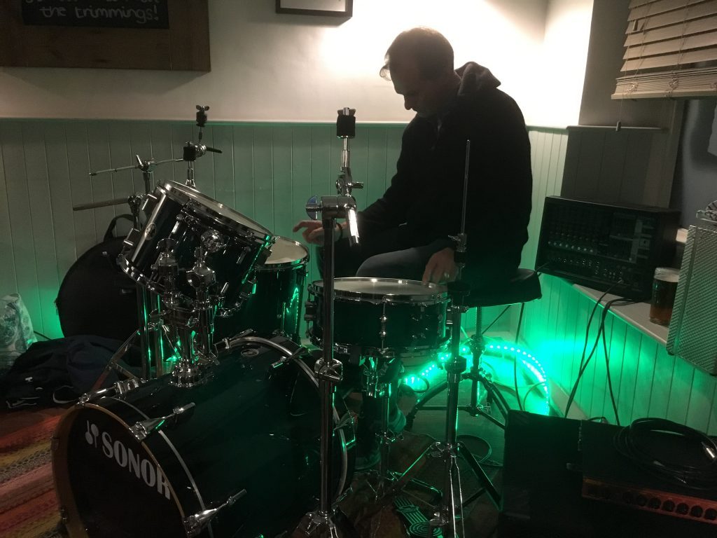 U-Turn Band Pete Roberts setting up drum kit